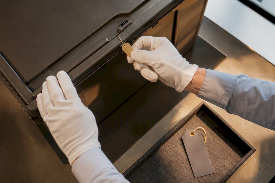 Hands checking sealed tape destruction container