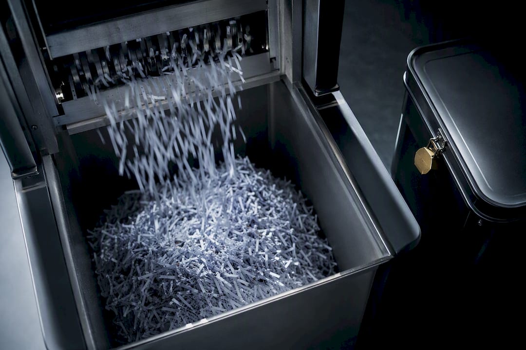 1789562303373_Confidential-paper-waste-entering-secure-destruction-machinery Confidential paper waste entering secure destruction machinery